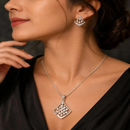 Close-up of model wearing pendant and earrings