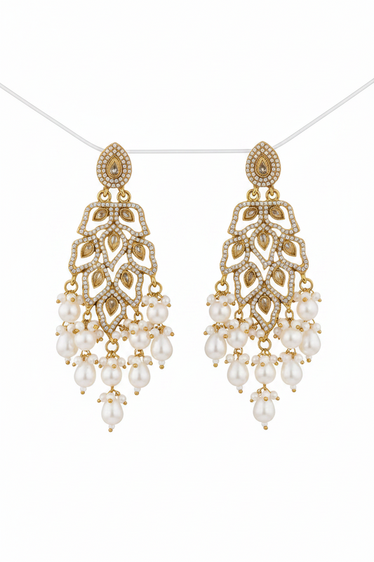 Gold and pearl chandelier earrings on a white background