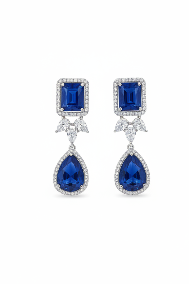 Pair of earrings with blue gemstones on a white background