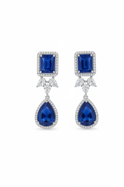 Pair of earrings with blue gemstones on a white background