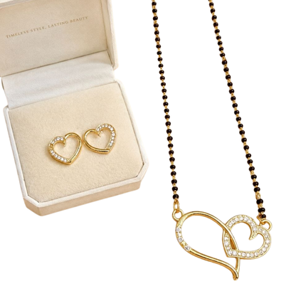 Gold heart-shaped necklace and earrings on a white background with an open jewelry box.