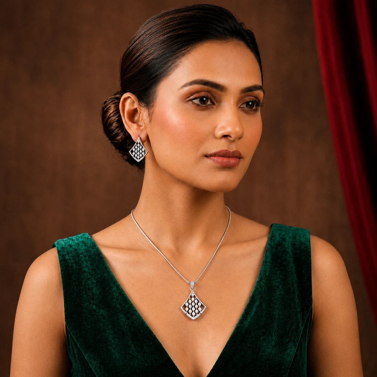 Model wearing silver plated pendant and earrings
