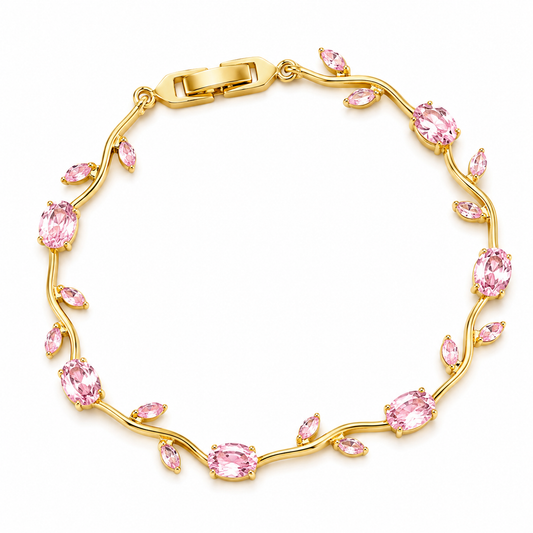 Gold bracelet with pink gemstones on a white background